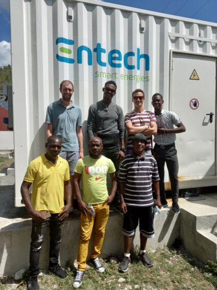 entech employees with haitians in training